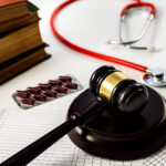 judge gavel, drugs and books on desk
