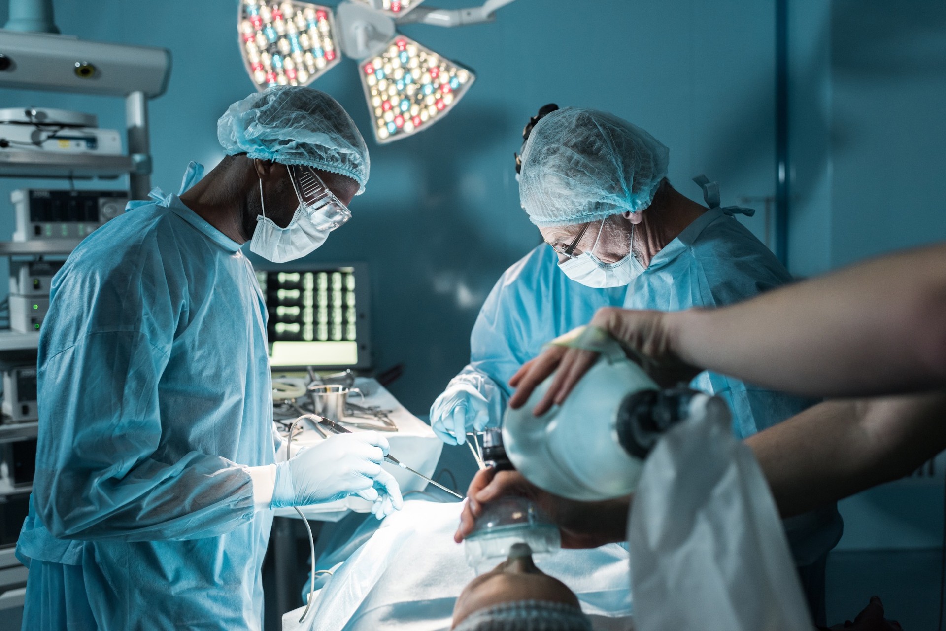 Surgeons performing operation in hospital operating room