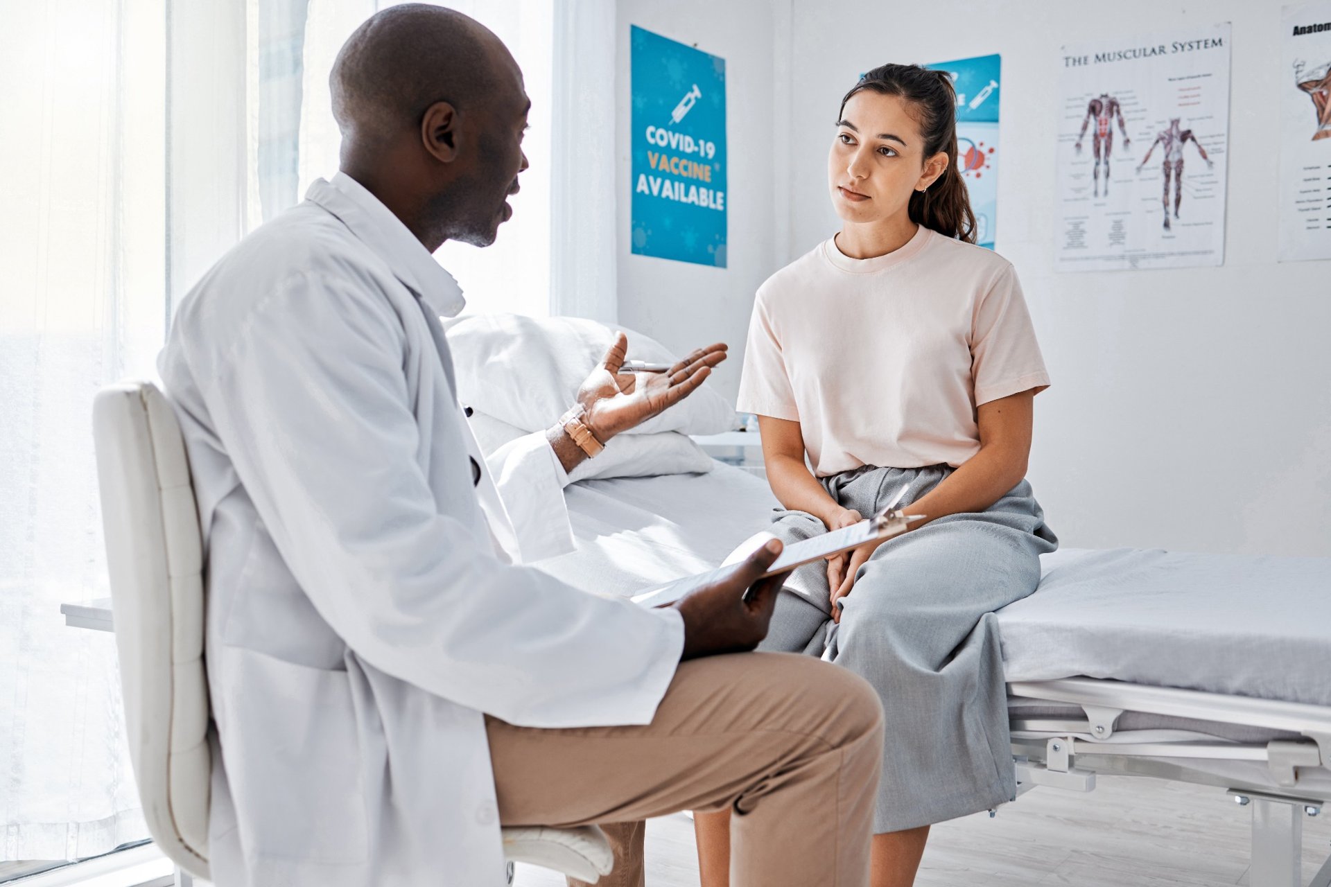 Doctor and patient discussing medical information in exam room