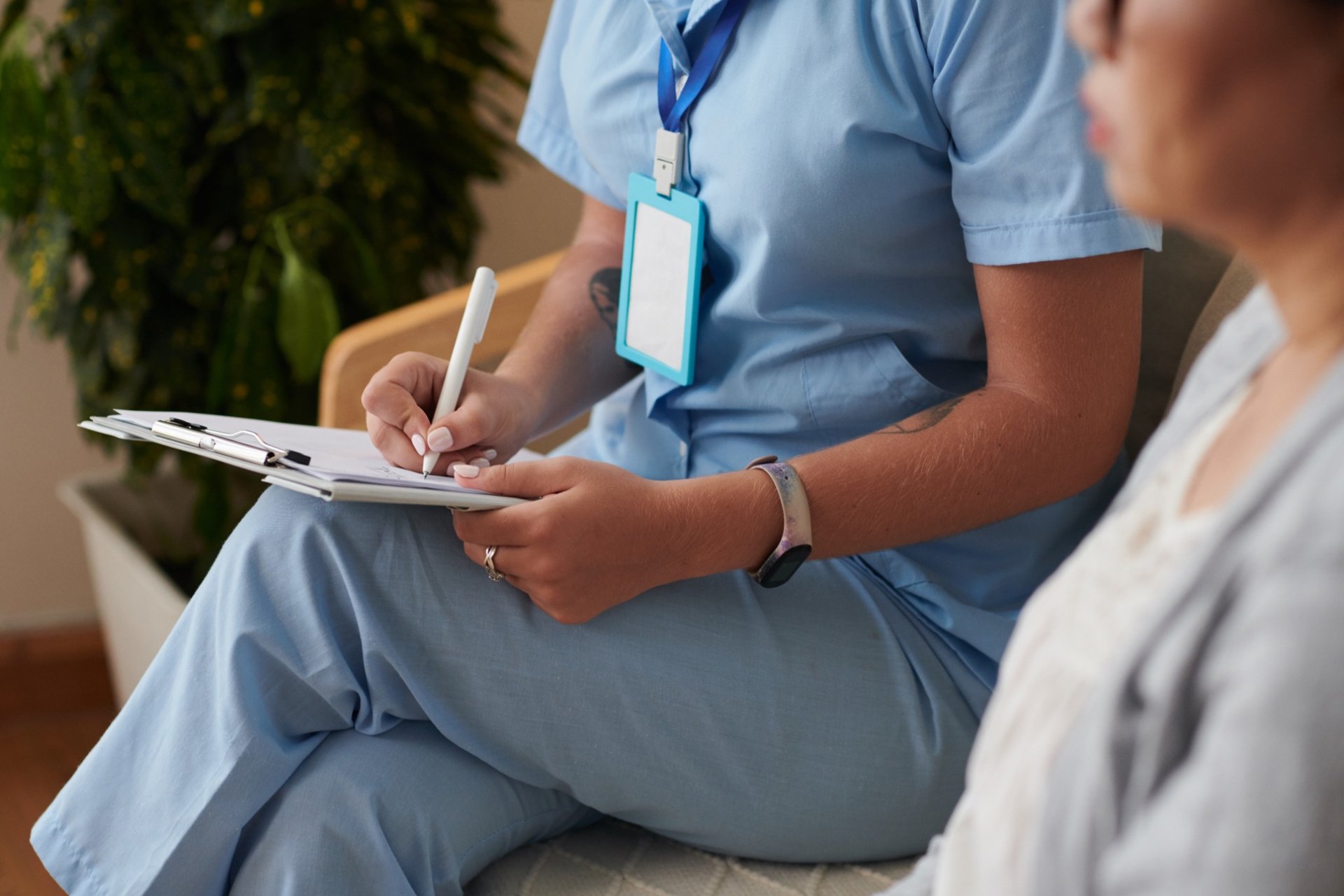 Healthcare professional writing on medical intake form
