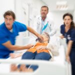 Medical team rushing elderly woman on hospital gurney in an emergency situation