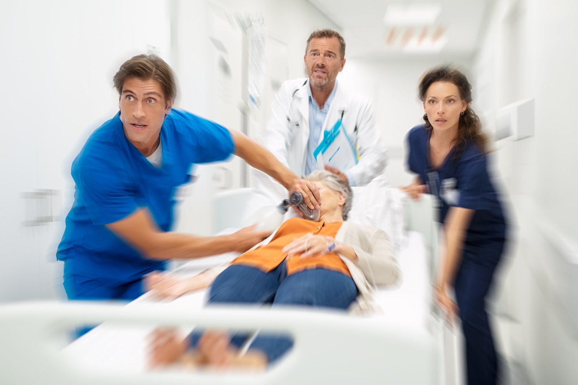 Medical team rushing elderly woman on hospital gurney in an emergency situation