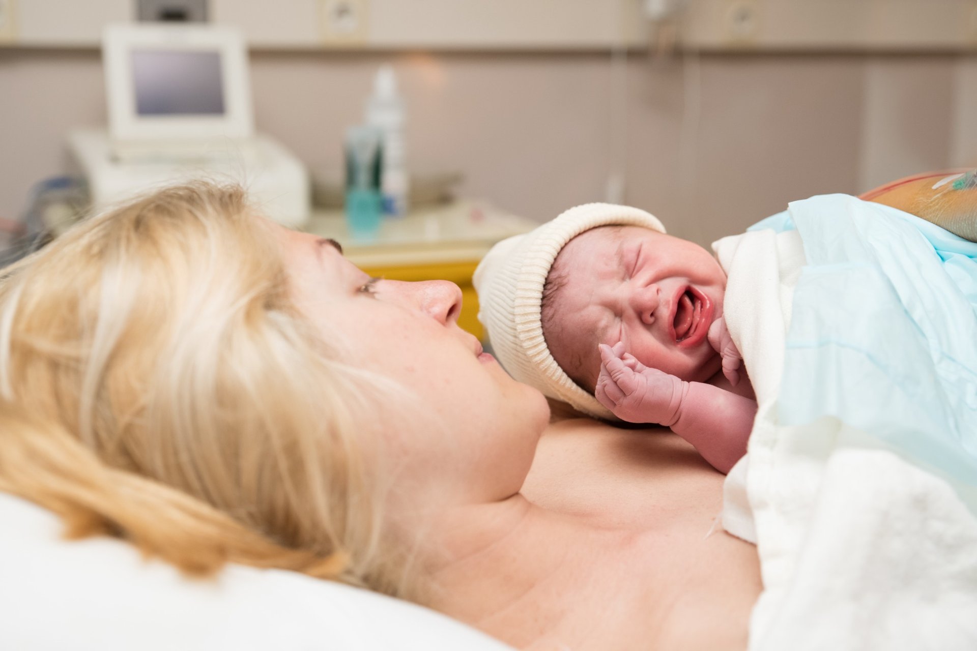 Newborn baby crying during skin-to-skin contact with mother after birth