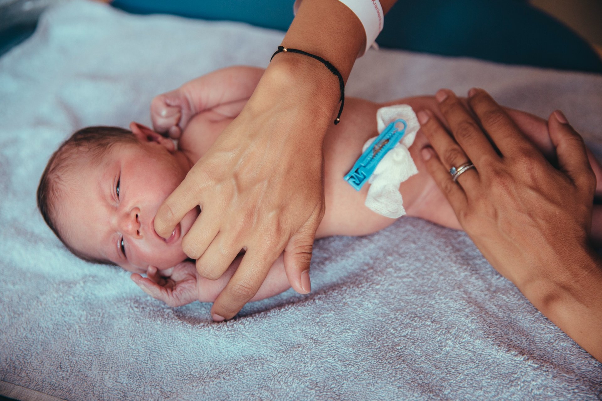 Newborn baby girl on towel receiving care and comfort