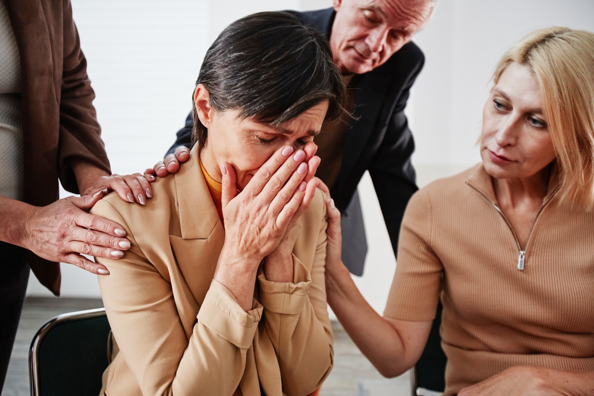 Woman in distress being comforted during emotional conversation